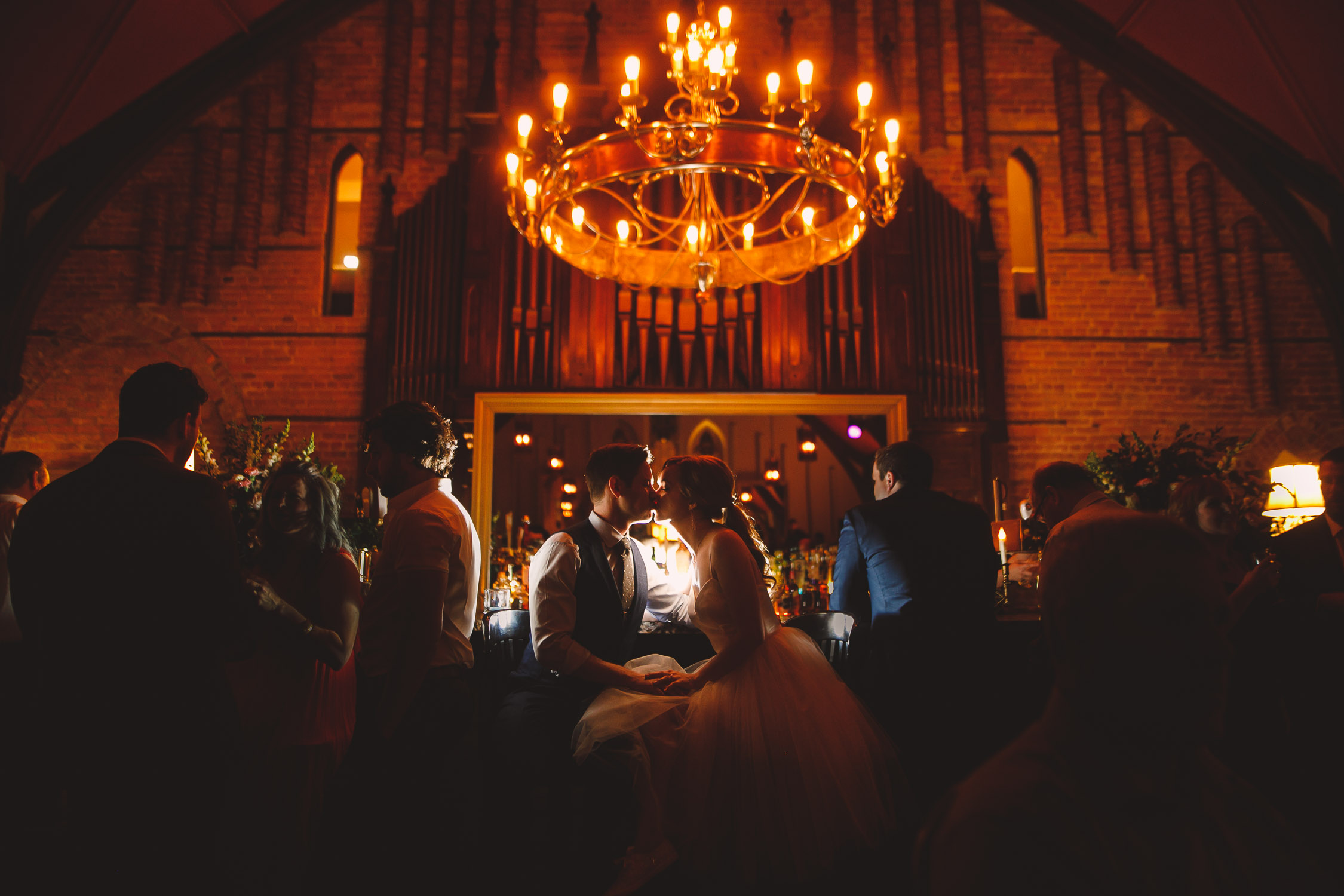 Kissing night photo at the bar, Revival House Wedding in Stratford.